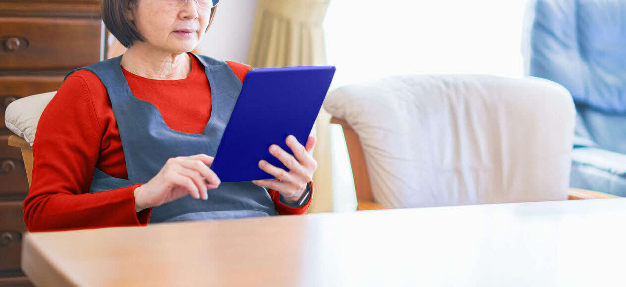 Lady learning how to use a tablet